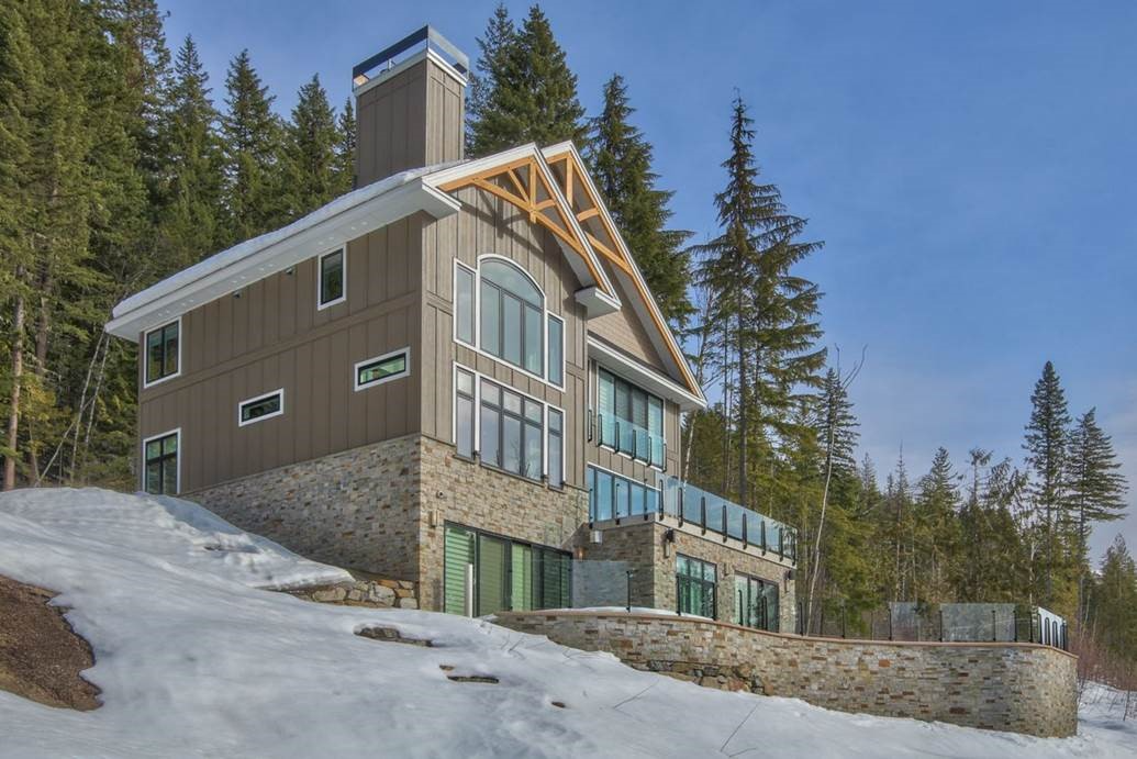 Rooham Electric powers a modern house with large windows on a snowy hillside