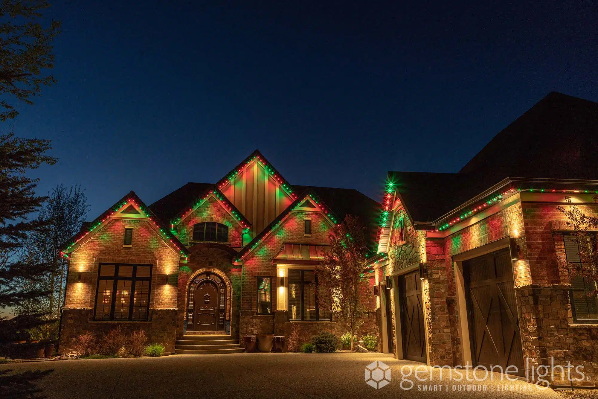 Residential electrical tobiano enhances a beautifully decorated house with vibrant holiday lights at dusk