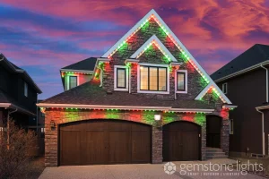 Permanent Christmas lights in Kamloops illuminate a festive house at sunset