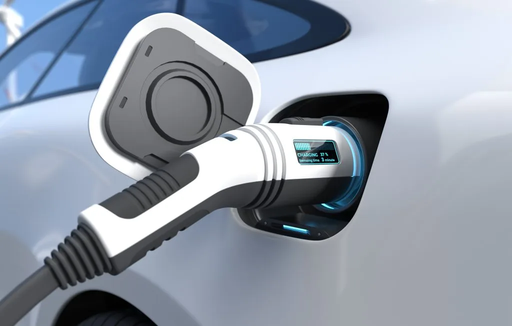 A charging cable is plugged into an electric vehicle